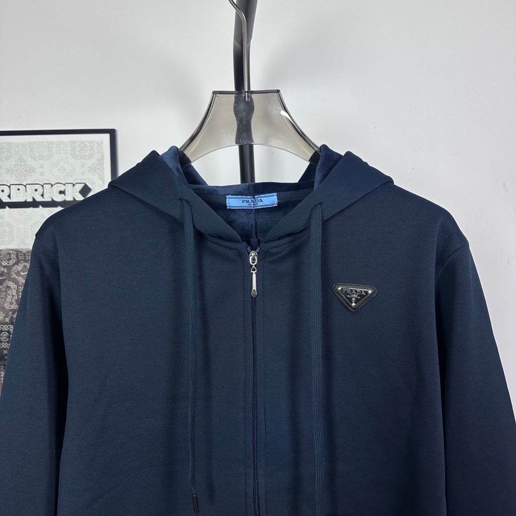 Dark navy zip hoodie with hood and small triangle logo on chest
