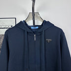 Dark navy zip hoodie with hood and small triangle logo on chest