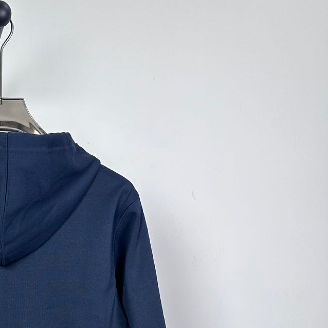 Dark navy hoodie hood opening with drawstring, hanging