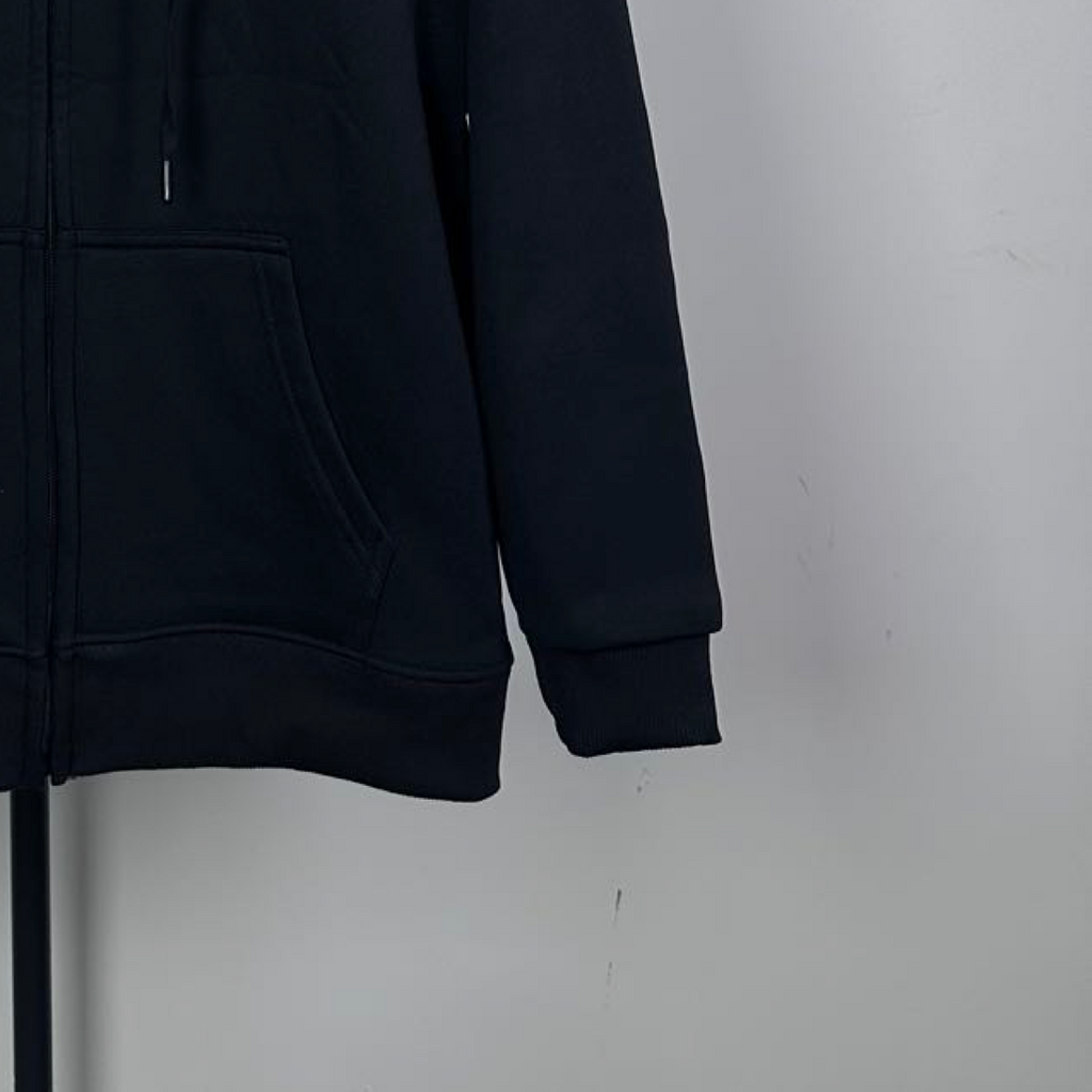 Dark zip-up hoodie sleeve and kangaroo pocket detail with ribbed hem