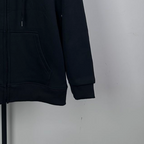 Dark zip-up hoodie sleeve and kangaroo pocket detail with ribbed hem