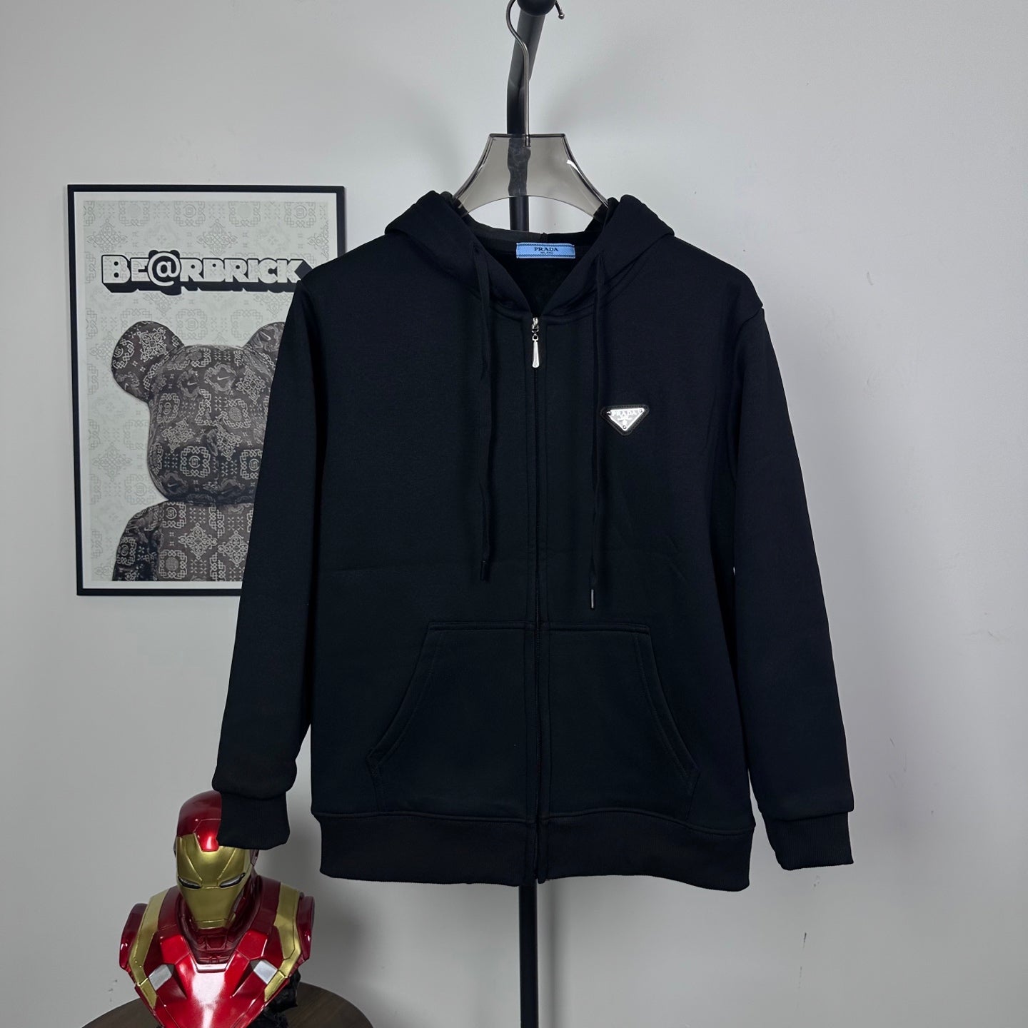 Dark zip-up hoodie with hood, front zipper, and front kangaroo pocket