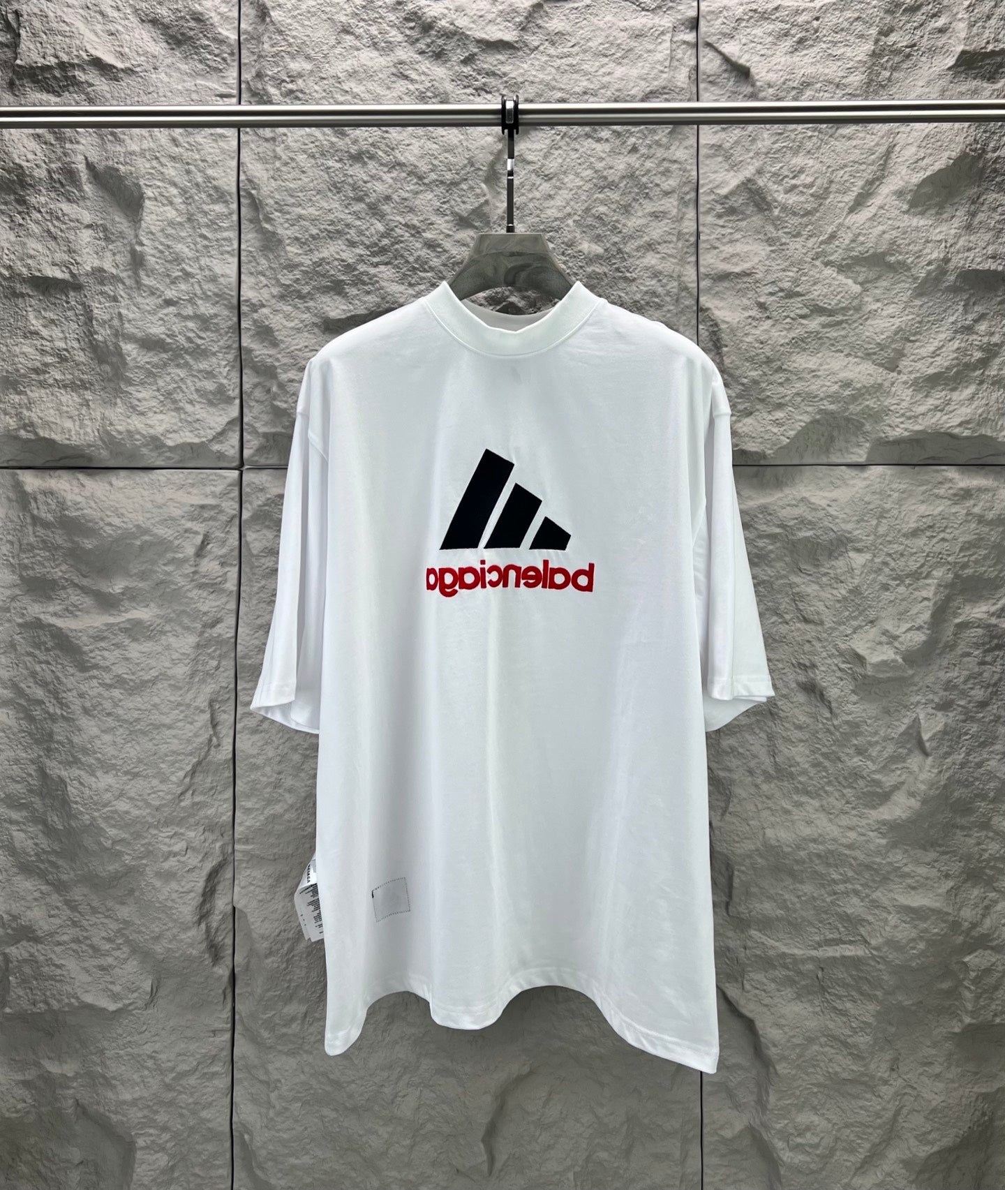 White T-shirt with large black graphic bars and red text print at center chest