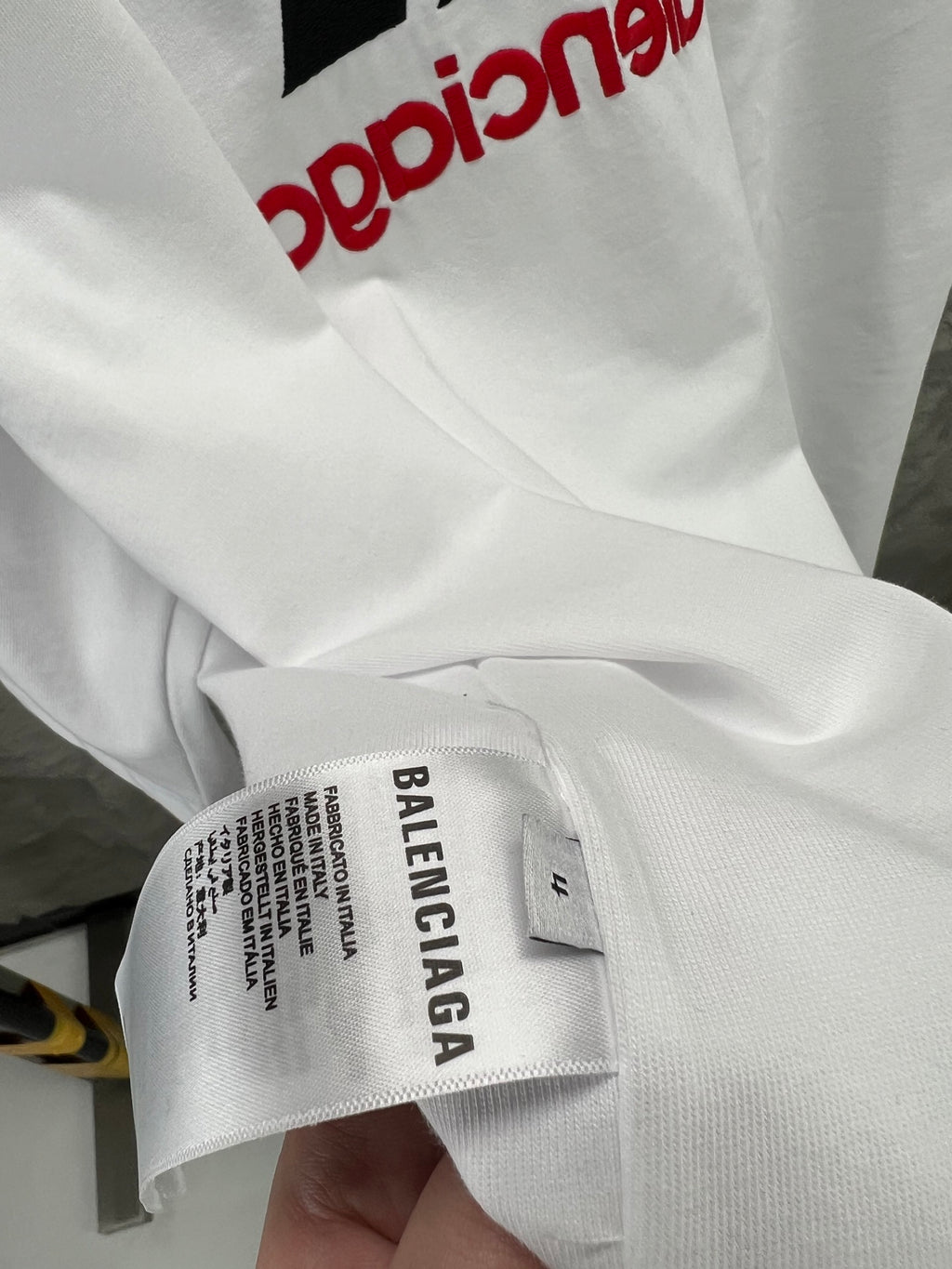 White size label on T-shirt sleeve reading BALENCIAGA