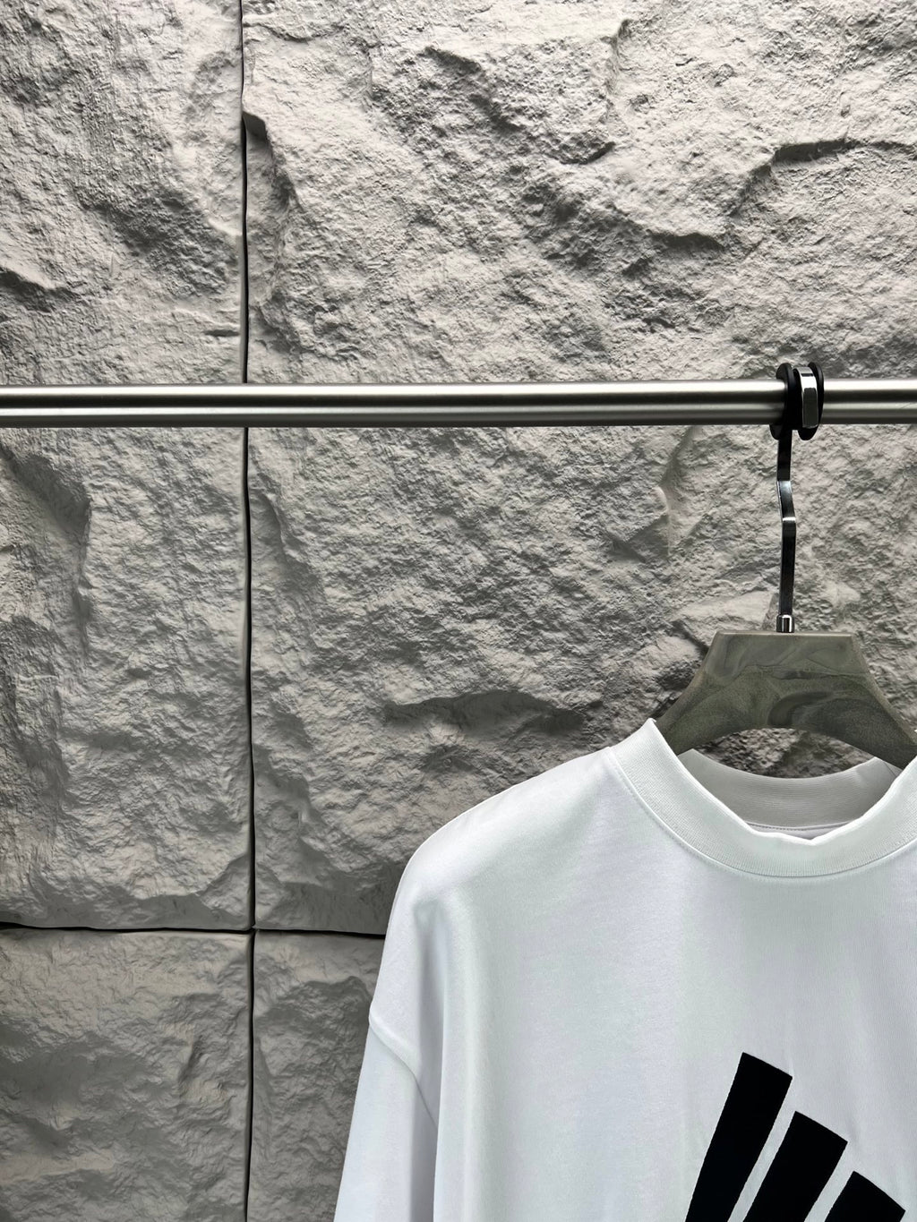 White T-shirt neckline with partial black graphic print on upper front