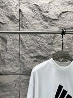 White T-shirt neckline with partial black graphic print on upper front