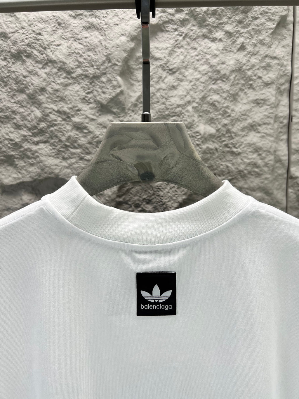 White T-shirt with small black logo at the upper chest