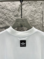 White T-shirt with small black logo at the upper chest