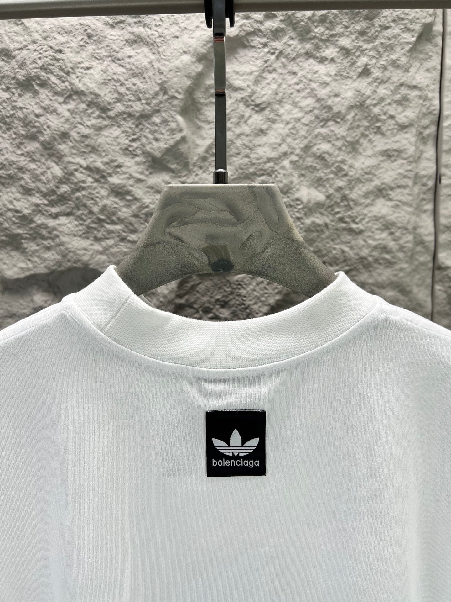 White T-shirt with small black logo at the upper chest