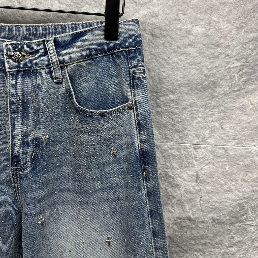 Light blue denim pants with detailed back pocket and scattered star-like embellishments