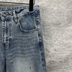 Light blue denim pants with detailed back pocket and scattered star-like embellishments