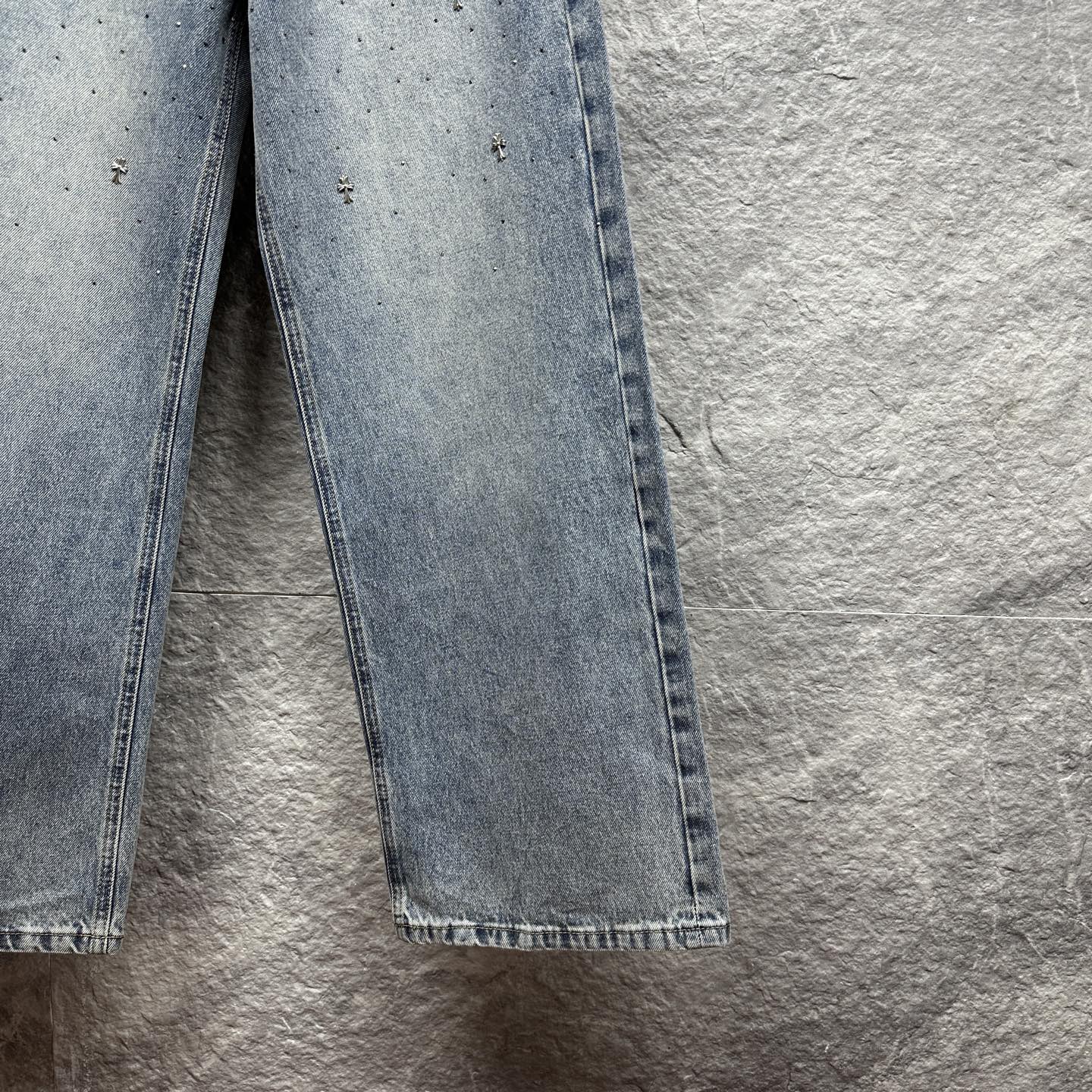 Light blue denim pants with wide straight legs and frayed hem at cuffs