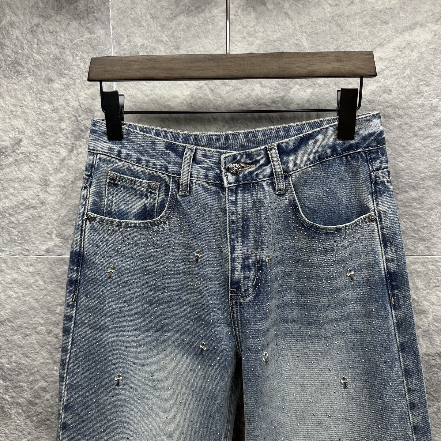 Light blue denim pants front view with waistband and two front pockets