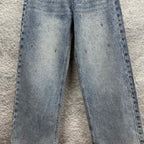 Light blue denim pants with scattered star-like speckles across the legs