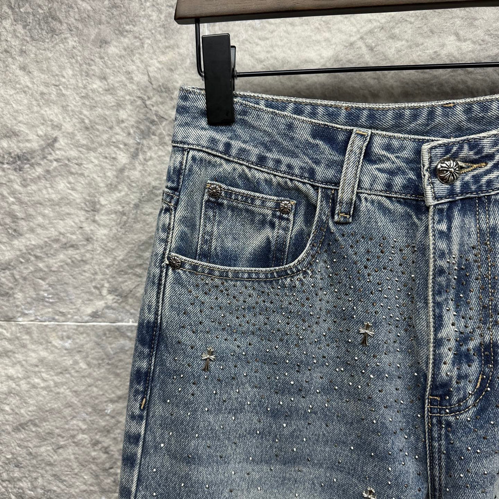 Light blue denim pants with left back pocket and scattered star-like embellishments