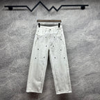 White denim pants with belt loops and all-over black dot cross pattern