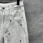 White denim pants with side pocket detail and black dot cross pattern