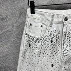 White denim pants with front curved pockets and black dot cross pattern