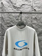 White crew-neck T-shirt with blue Balenciaga logo graphic on the front