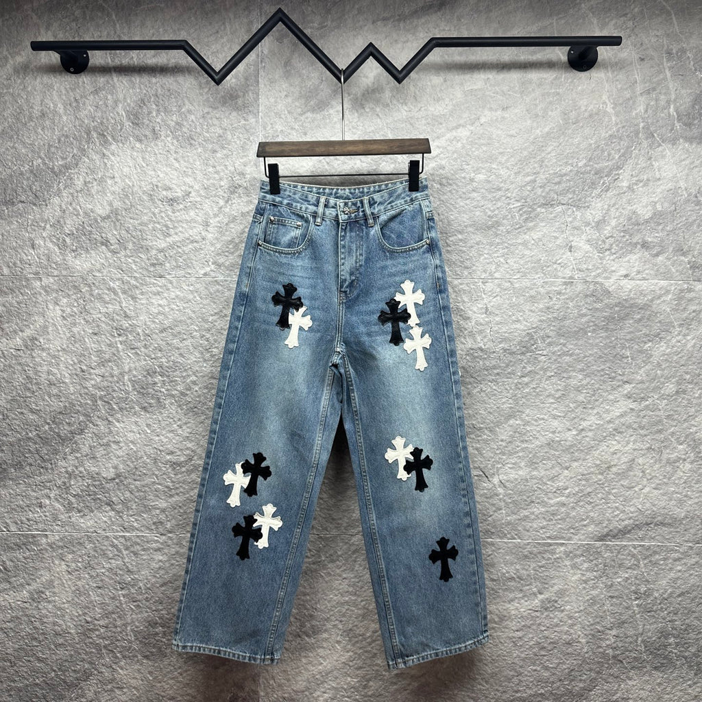 Light blue denim pants with scattered black and white cross applique designs