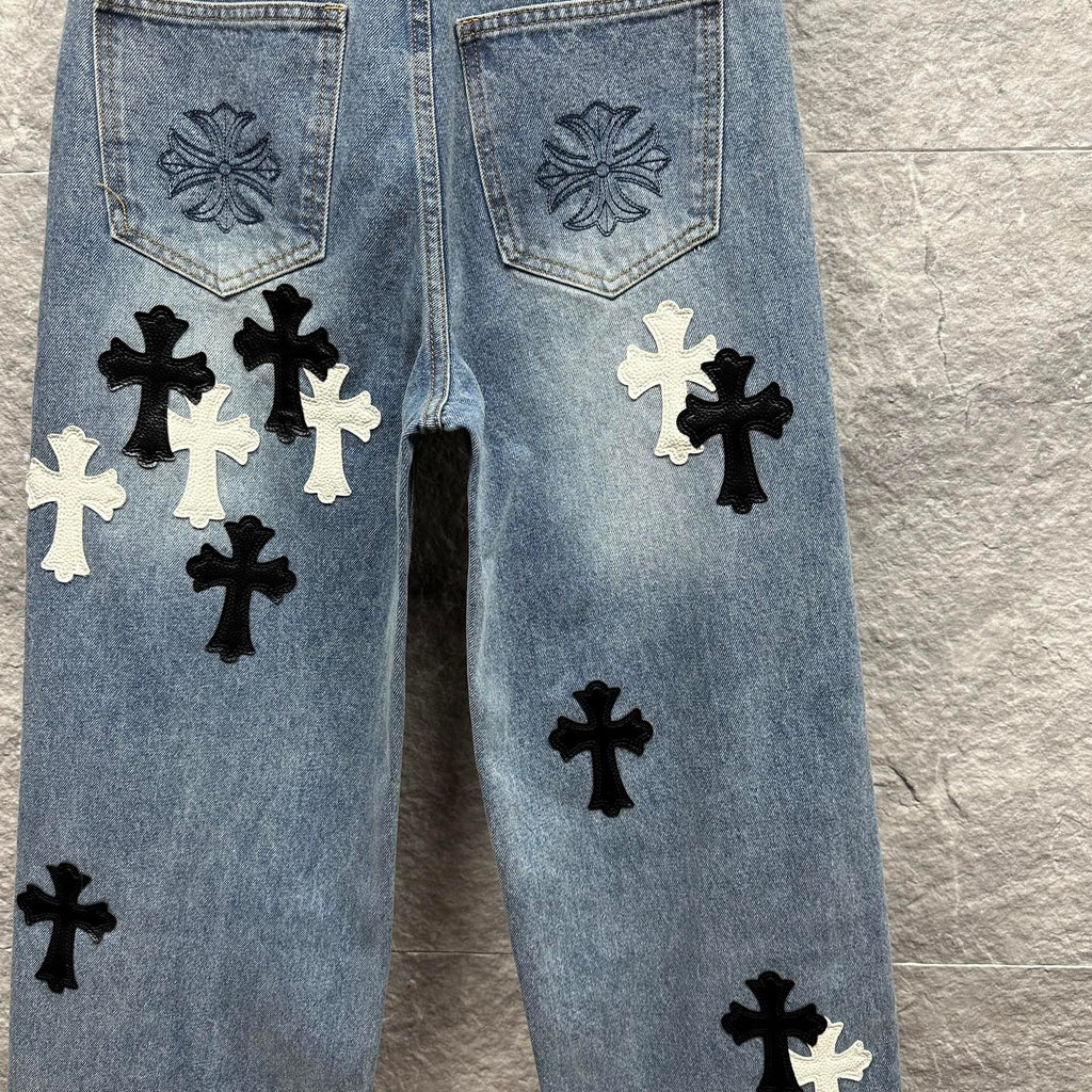 Light blue denim pants back view with pocket embroidery and black and white cross applique
