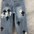 Light blue denim pants back view with pocket embroidery and black and white cross applique