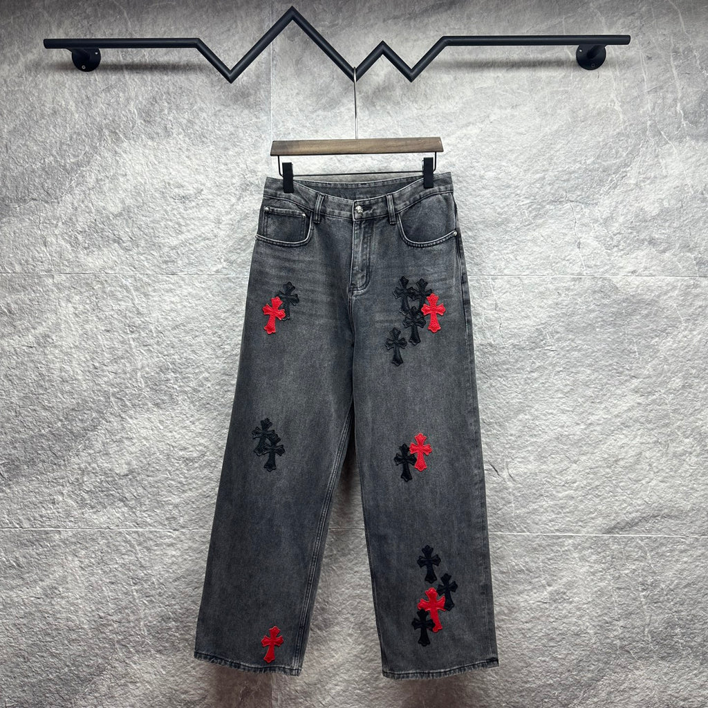 Grey denim pants with cross embroidery in red and black, front view