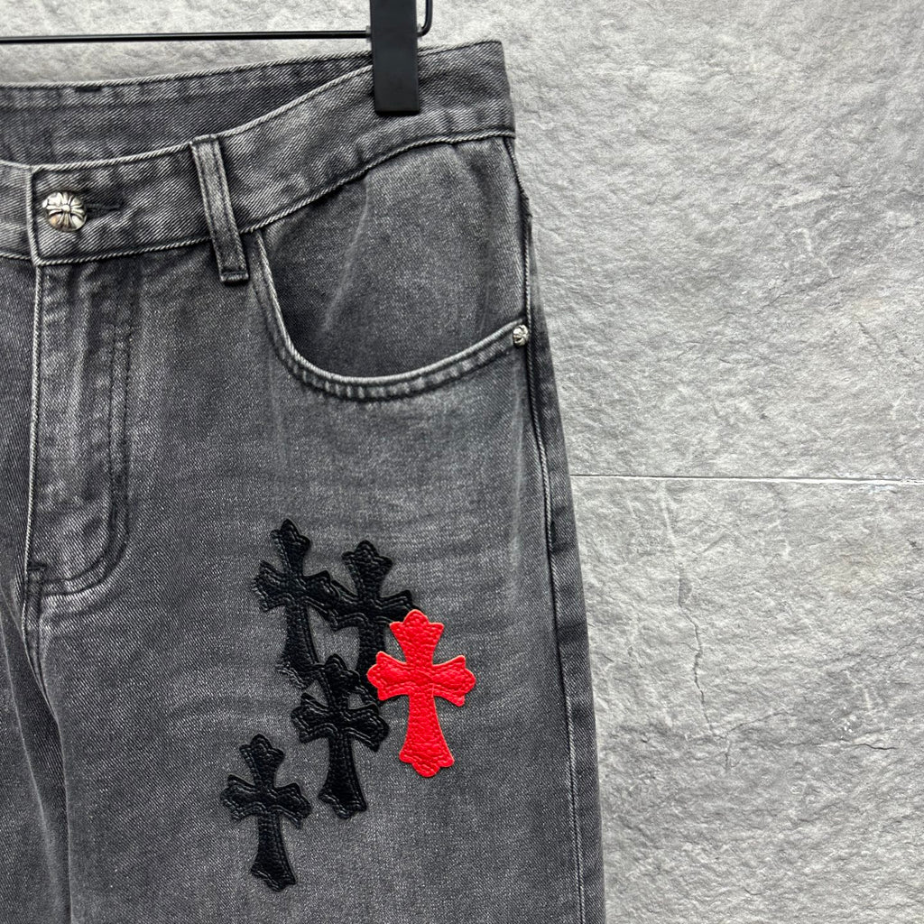 Grey denim pants with cross embroidery near side thigh and hem