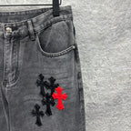 Grey denim pants with cross embroidery near side thigh and hem