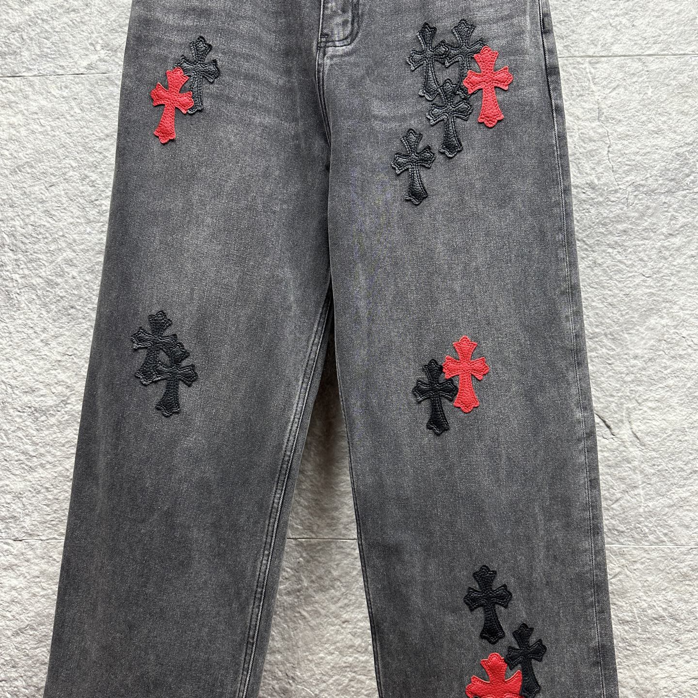 Grey denim pants with scattered cross embroidery in red and black