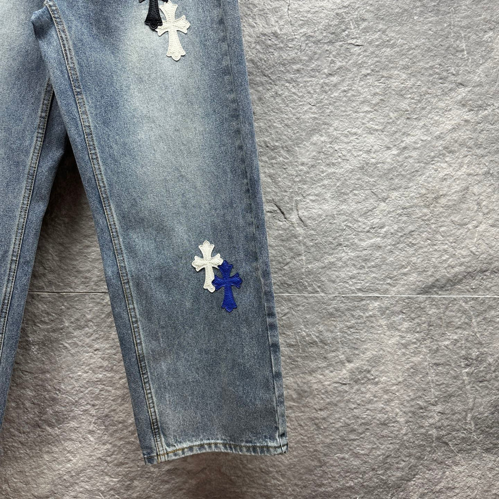 Light-wash denim pants with cross patches on the side seam, straight leg