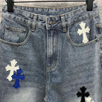 Light-wash denim pants with cross patches on the front and pockets, button waistband