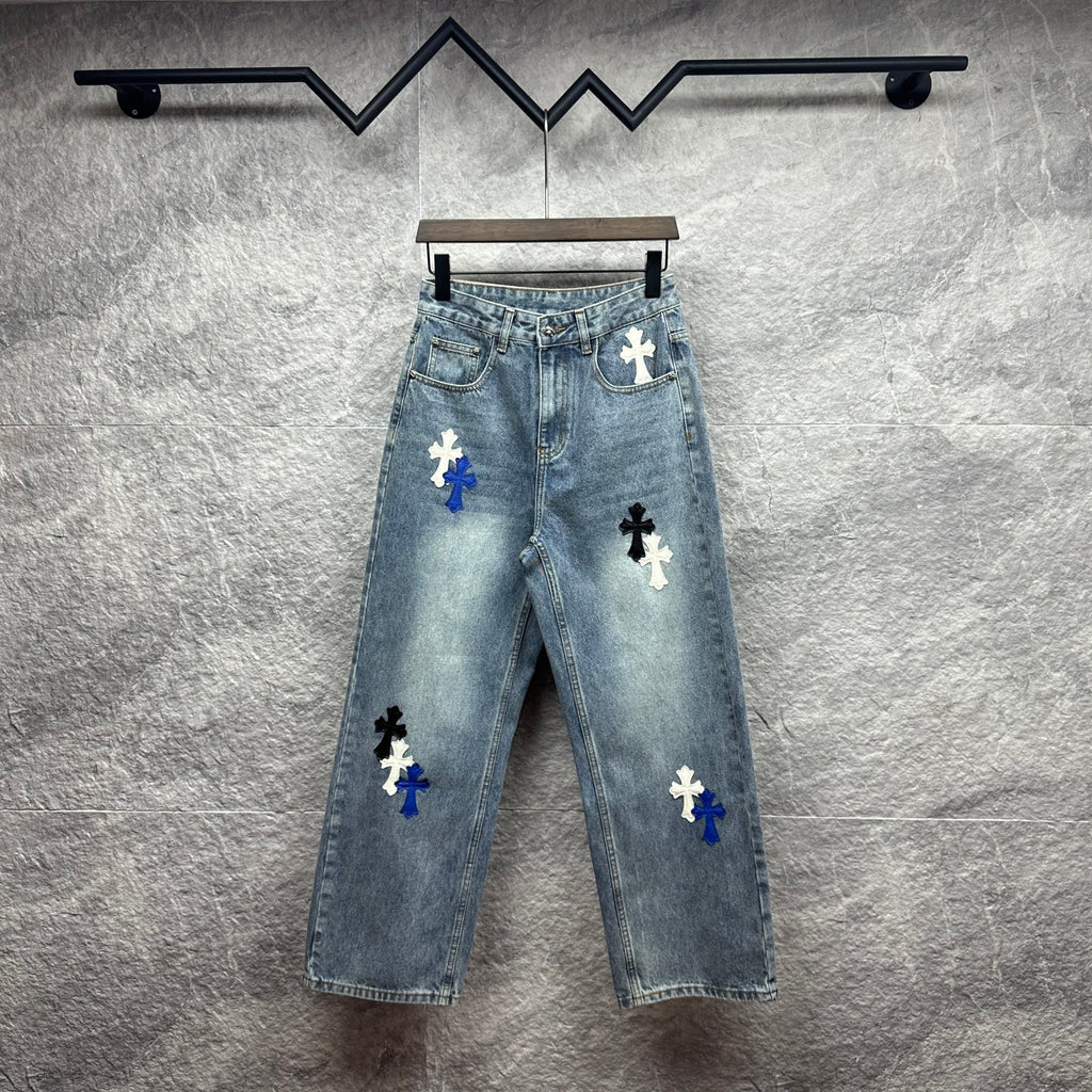 Light-wash denim pants with blue and white cross patches, button fly, straight leg
