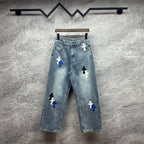 Light-wash denim pants with blue and white cross patches, button fly, straight leg