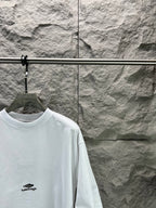 White crew-neck T-shirt with small chest logo; short sleeves and crew collar.