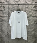 White crew-neck T-shirt with small Balenciaga logo on the chest.