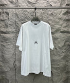 White crew-neck T-shirt with small Balenciaga logo on the chest.