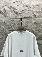 White crew-neck T-shirt with small chest logo and wide neckline.