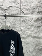 Black short-sleeve T-shirt with Balenciaga script logo, angled shoulder view