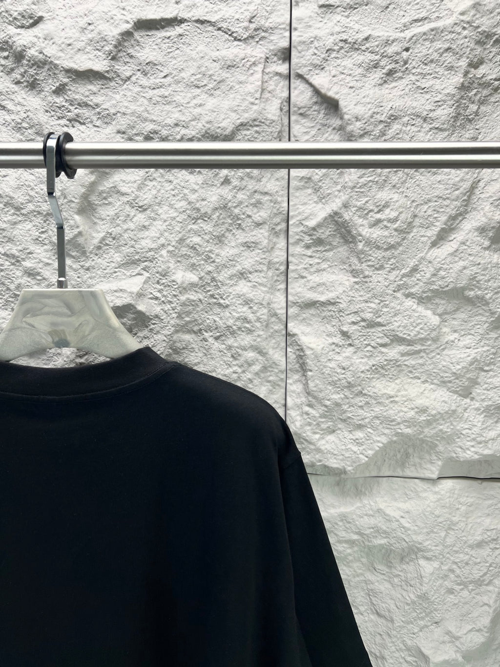 Black short-sleeve T-shirt back view, close to shoulder