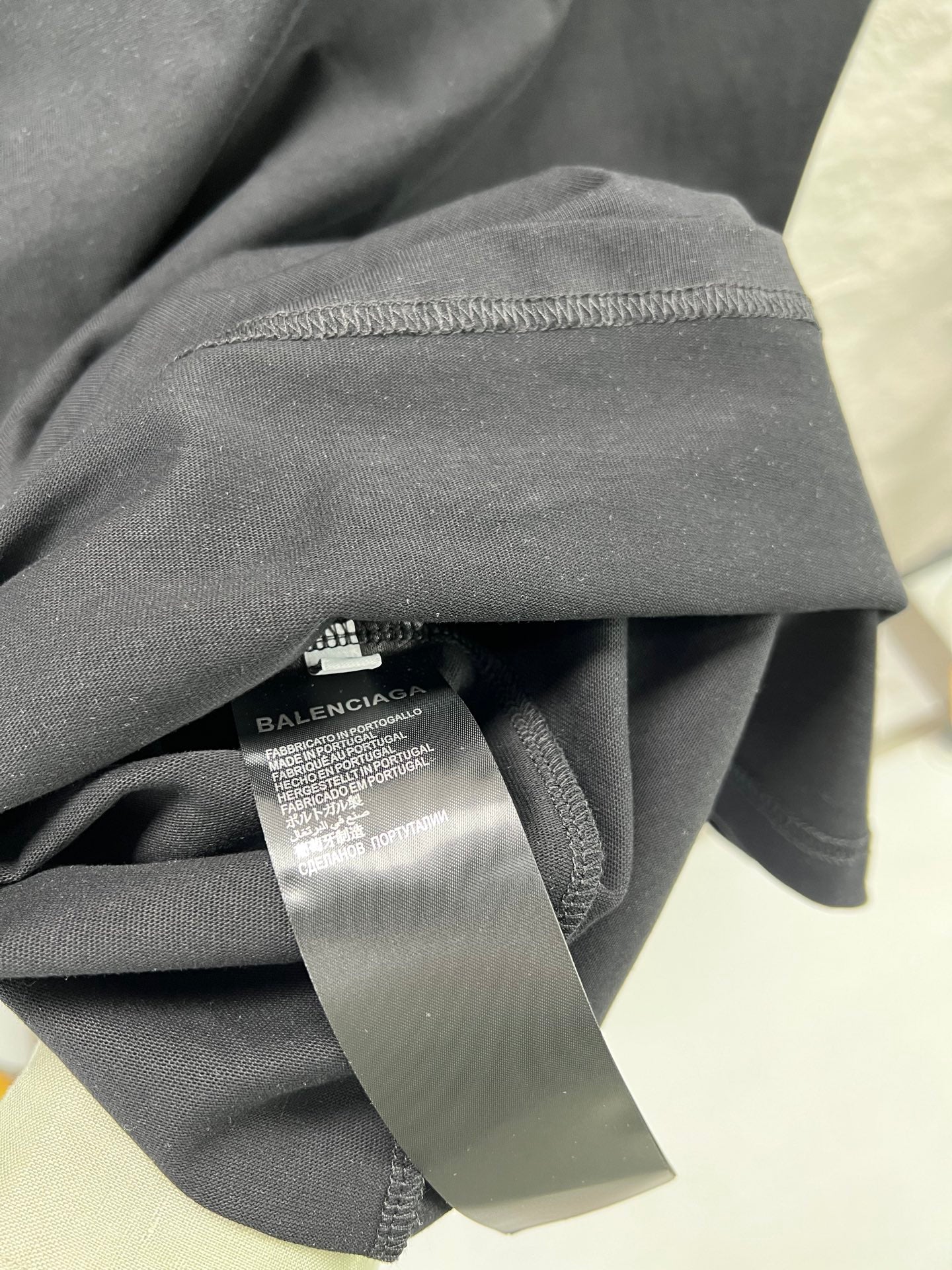 Gray T-shirt fabric with Balenciaga neck label tag detail