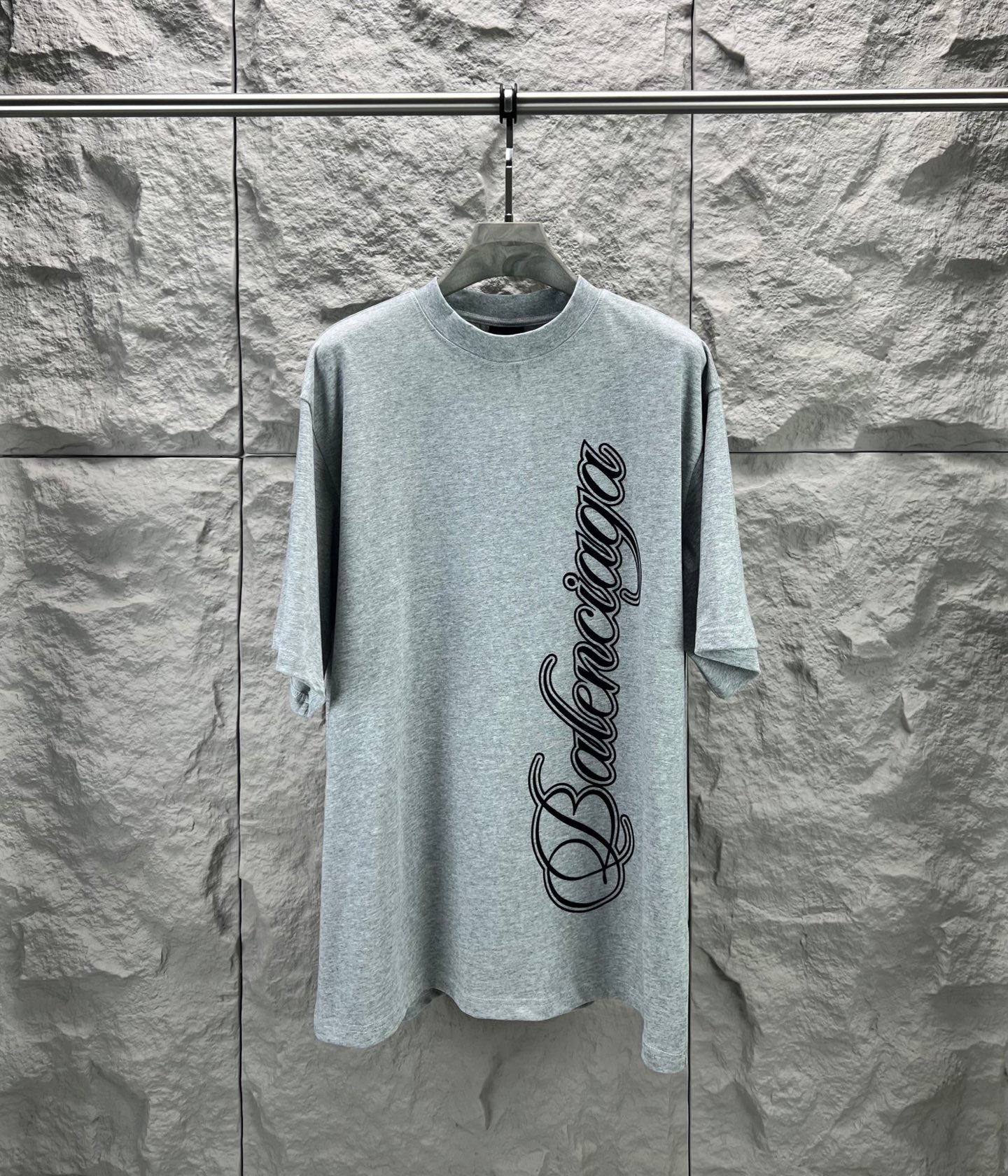Light blue short-sleeve T-shirt with Balenciaga logo script graphic on front