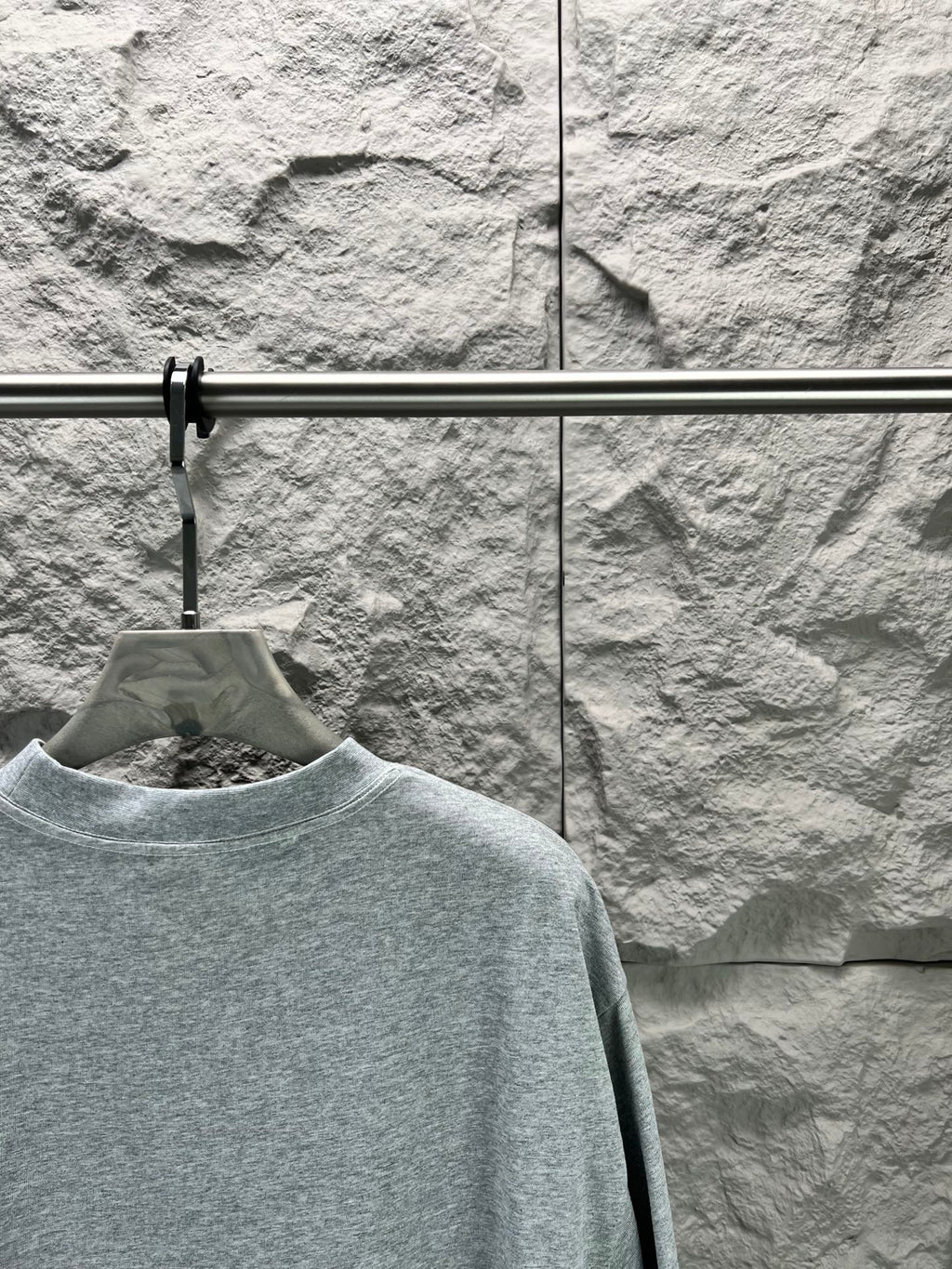 Light blue short-sleeve T-shirt close view of crew neck and shoulder seam