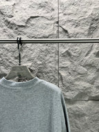 Light blue short-sleeve T-shirt close view of crew neck and shoulder seam
