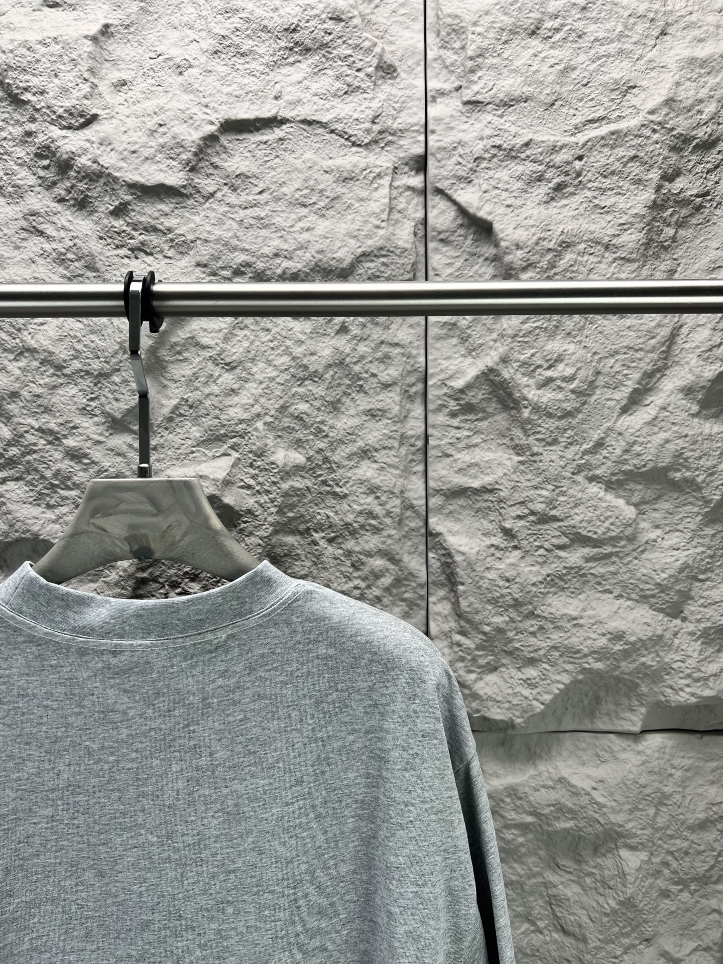 Light blue short-sleeve T-shirt close view of crew neck and shoulder seam