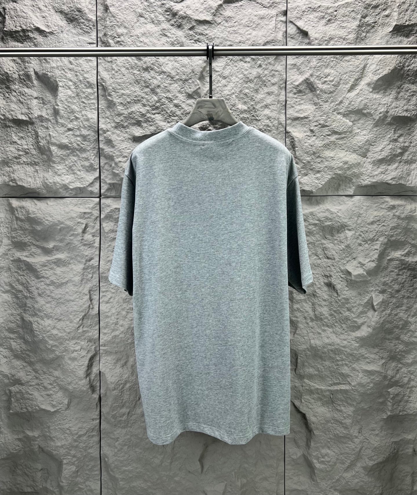 Light blue short-sleeve T-shirt on hanger, crew neck and relaxed straight silhouette