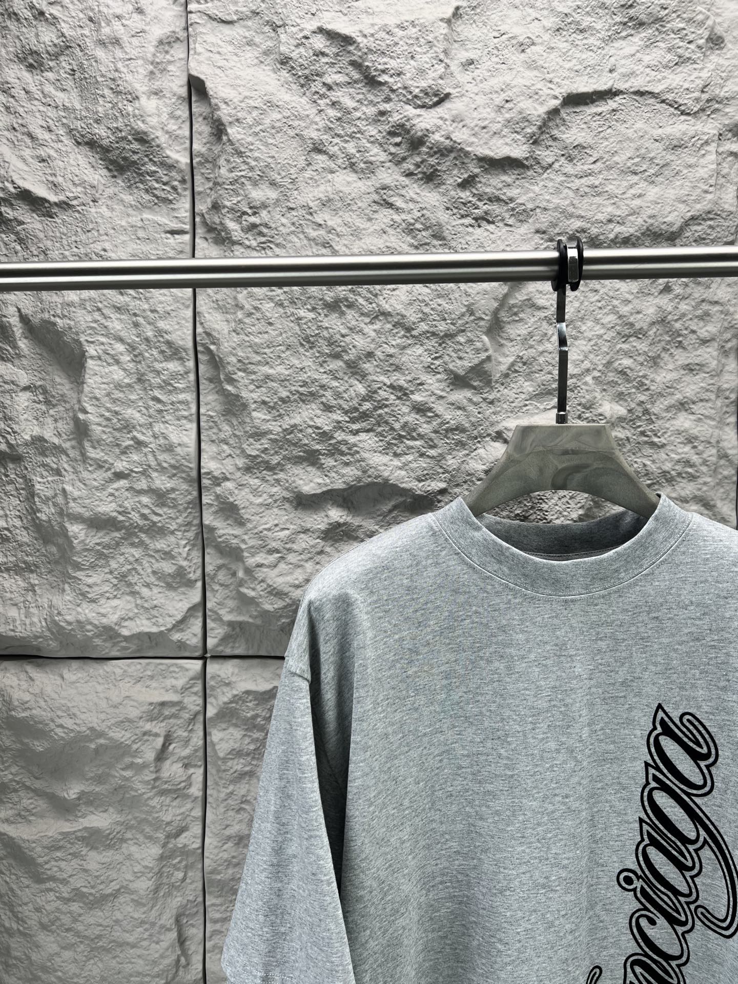 Light blue short-sleeve T-shirt with Balenciaga logo, upper front close-up