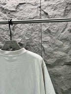 Light gray short-sleeve T-shirt back with partial view of sleeve and shoulder