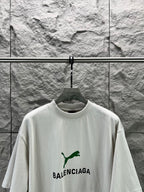 Light gray short-sleeve T-shirt with green puma-style and BALENCIAGA logo