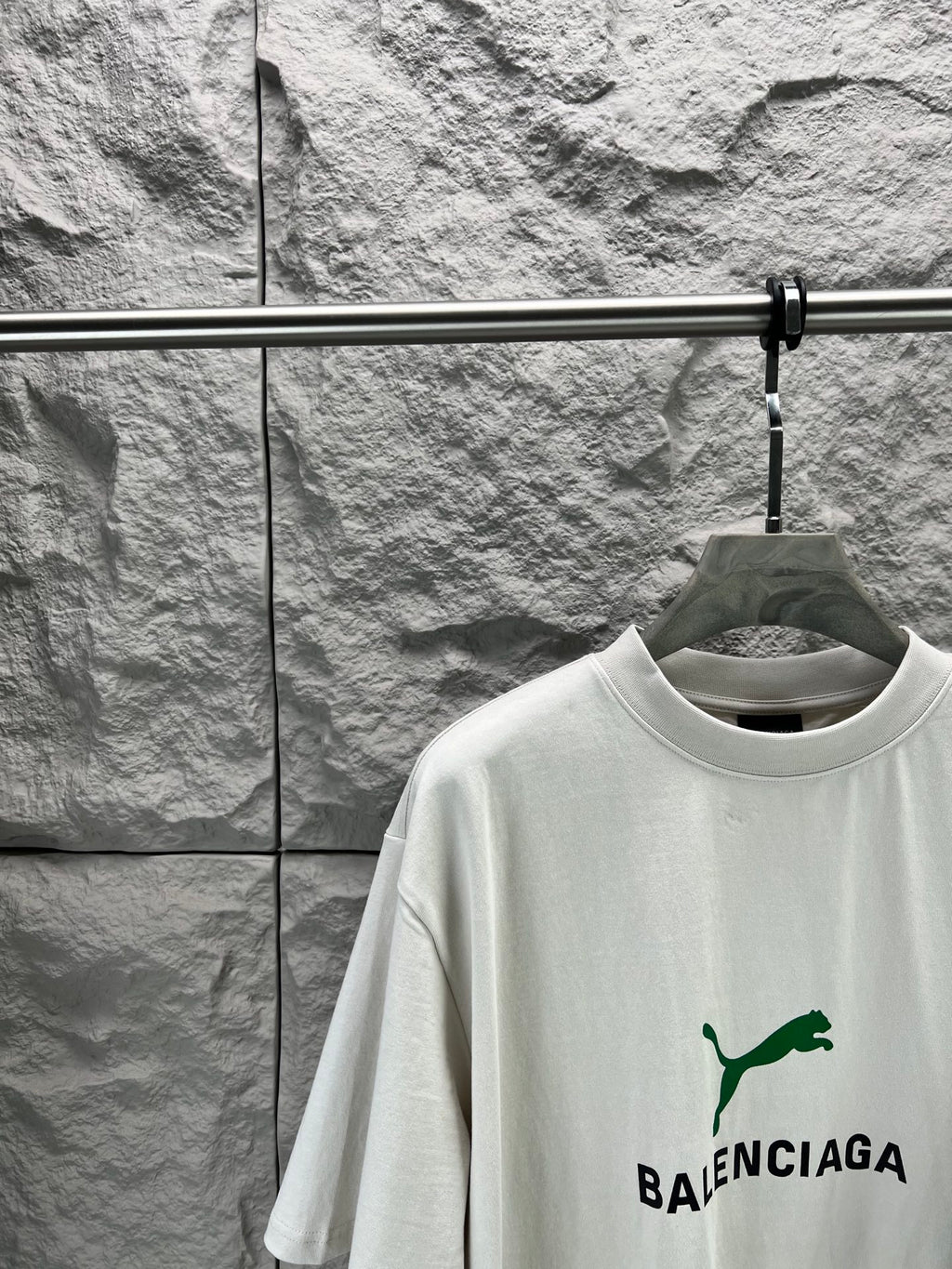 Light gray short-sleeve T-shirt front close-up with green Balenciaga logo